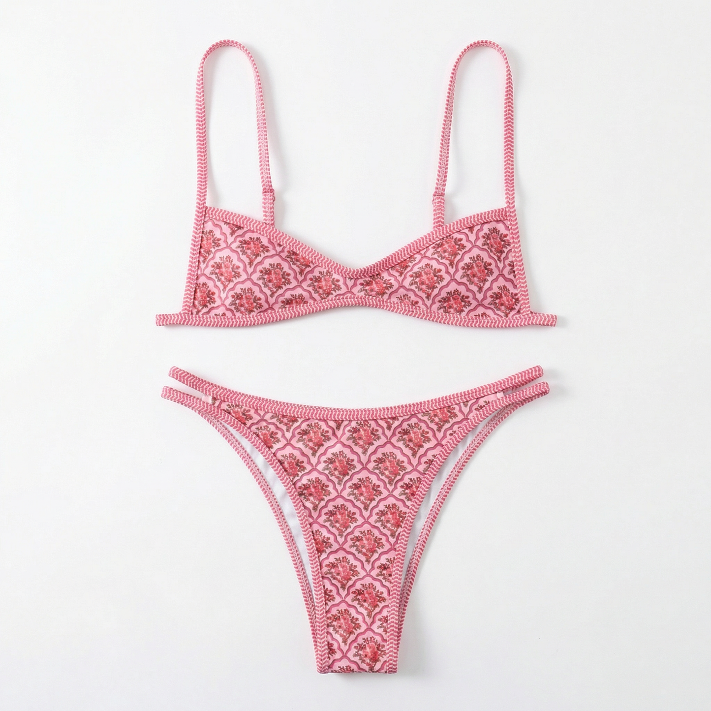 Pink bikini set with intricate patterns on a white background