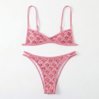Pink bikini set with intricate patterns on a white background