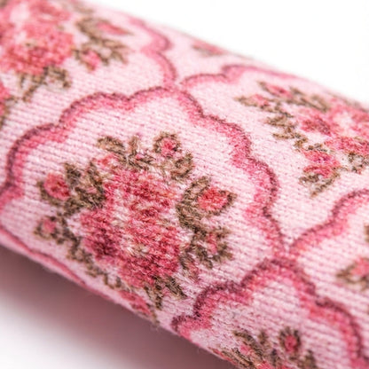 Close-up of pink floral fabric on a white background